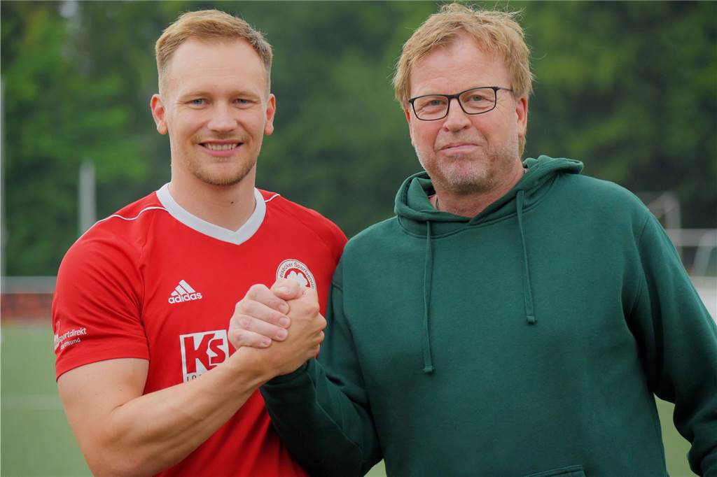 Kevin Loke (li.) wechselt vom ETuS/DJK Schwerte zum Geisecker SV und wird vom Sportlichen Leiter Thomas Redel am Buschkampweg begrüßt.