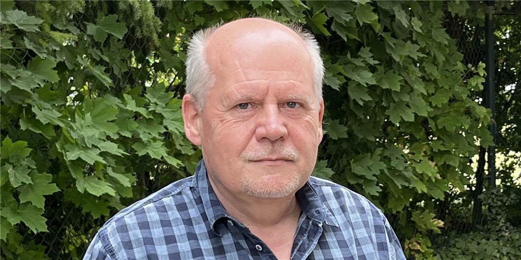 Klaus Kriebel handelt mit fairen Produkten – hat aber eine Sorge Klaus Kriebel steht vor einer Hecke.