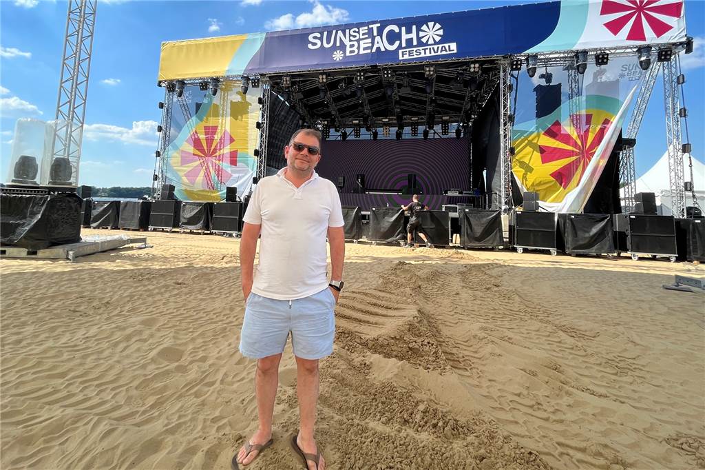 Das erste Sunset Beach Festival: Schlecht-Wetter-Prognosen und Mücken Martin Königsmann steht vor der Bühne vom Sunset Beach Festival.