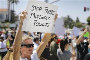Menschen protestieren in Carlsbad, Kalifornien, mit Schildern gegen die US-Einwanderungspolitik. Foto: Howard Lipin / San Diego Union-Tribune