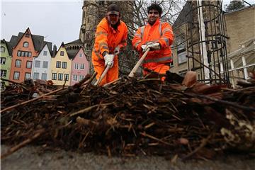 Mitarbeiter der Stadt schieben in Köln Treibgut zusammen. Foto: Oliver Berg