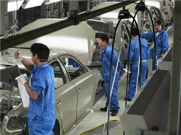 Mitarbeiter im Volkswagen-Werk in Nanjing; nahe Shanghai, China, arbeiten an Karosserien einer Passat-Limousine für den chinesischen Markt. Foto: Heiko Lossie