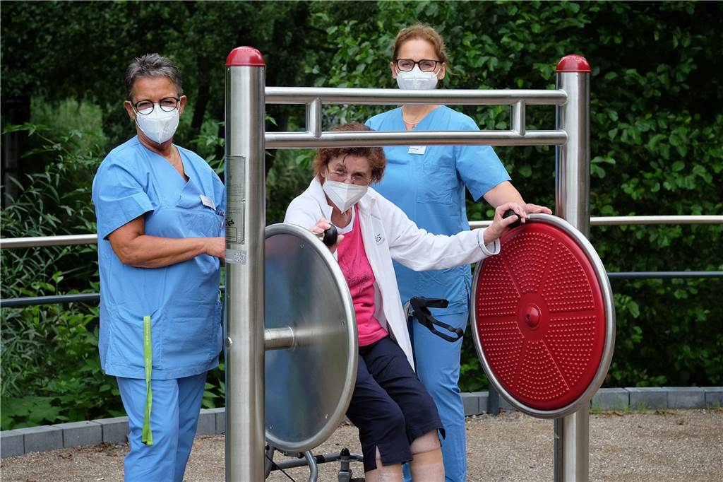 Neuer Gesundheitspark am Krankenhaus ist jetzt für alle zugänglich Mitarbeiterinnen der physiotherapeutischen Abteilung des Krankenhauses erläutern einer Nutzerin ein Gerät zur Förderung von Bewegungsanreizen.