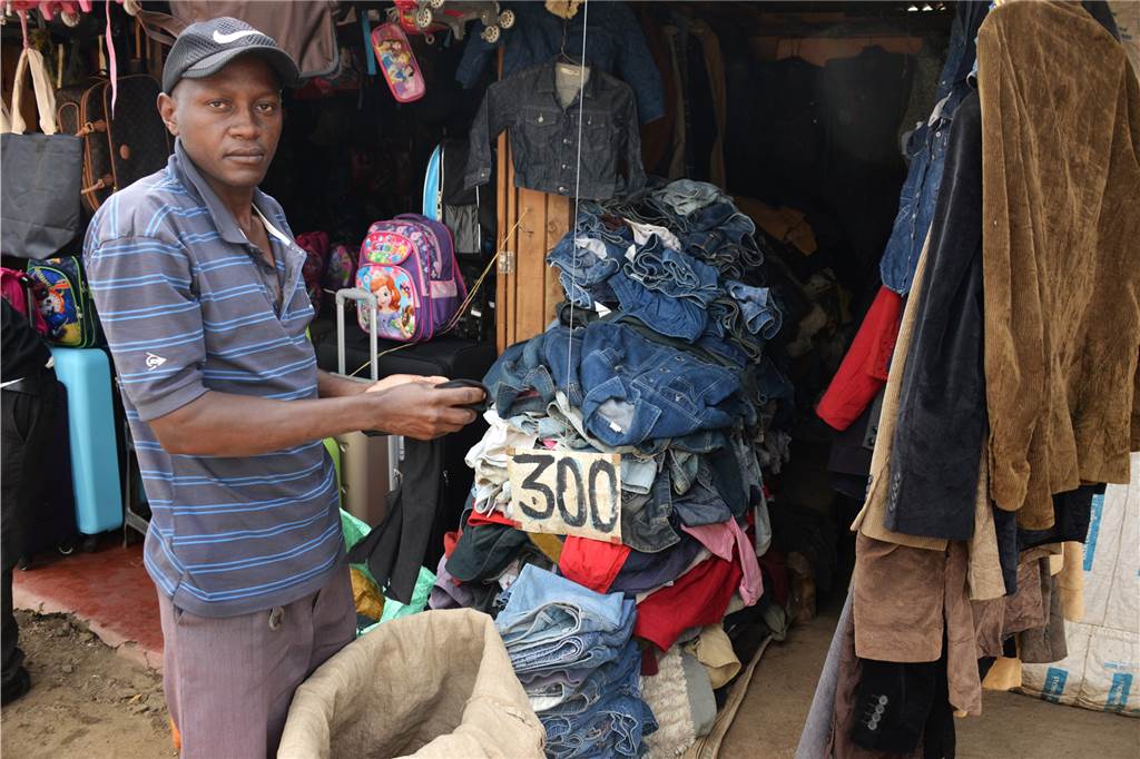 Mode - eine Klimasünde vom Laufsteg bis zur Tonne Auf einem Markt im kenianischen Nairobi verkauft ein Händler Mode, die aus Europa zurückgekommen ist.