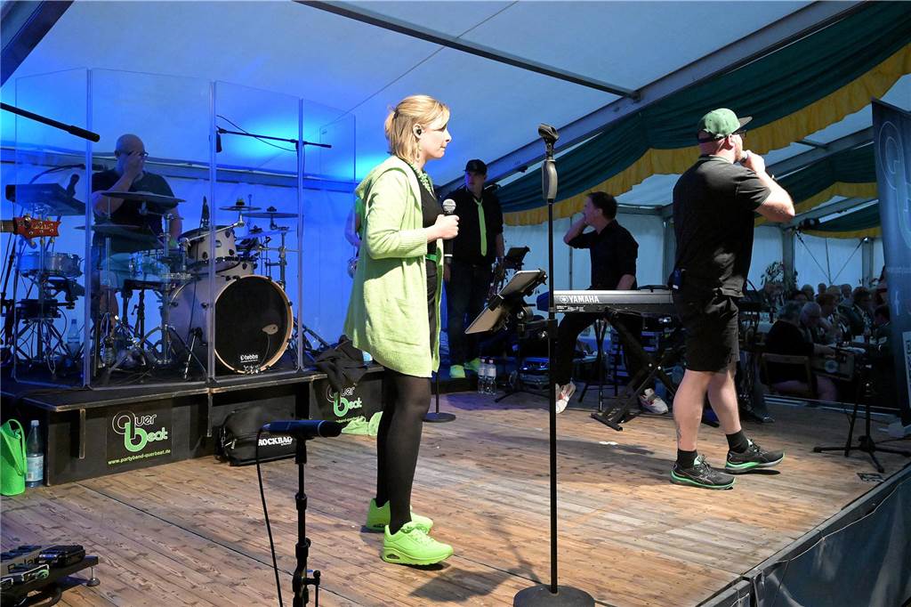Eine Frau steht auf der Bühne und singt. 