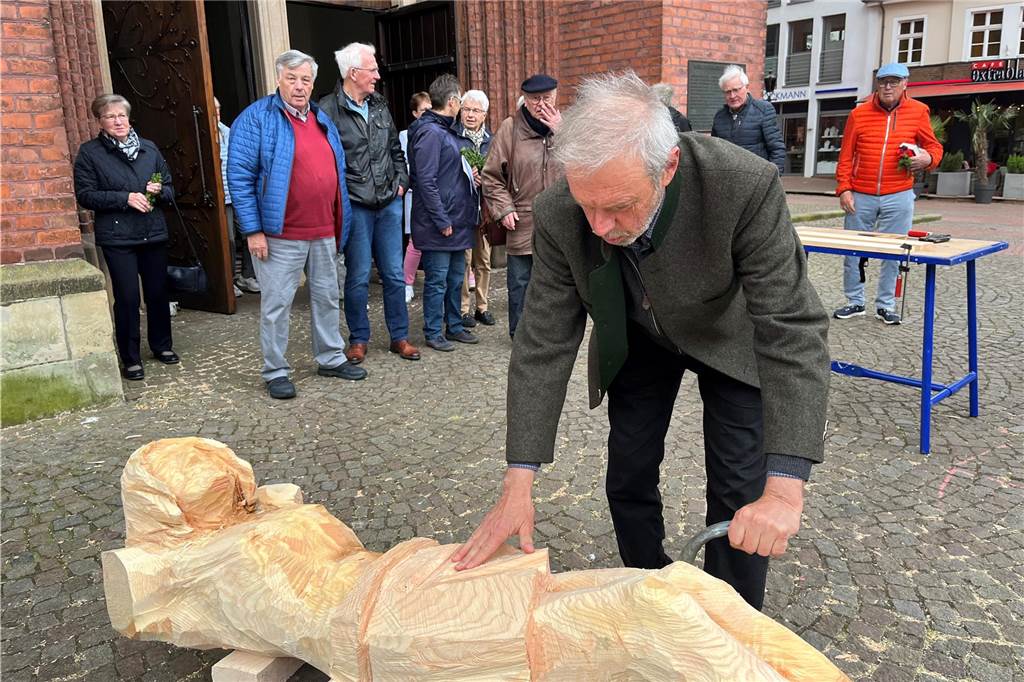 Der Künstler schiebt seine Arbeit auf den Kirchplatz.