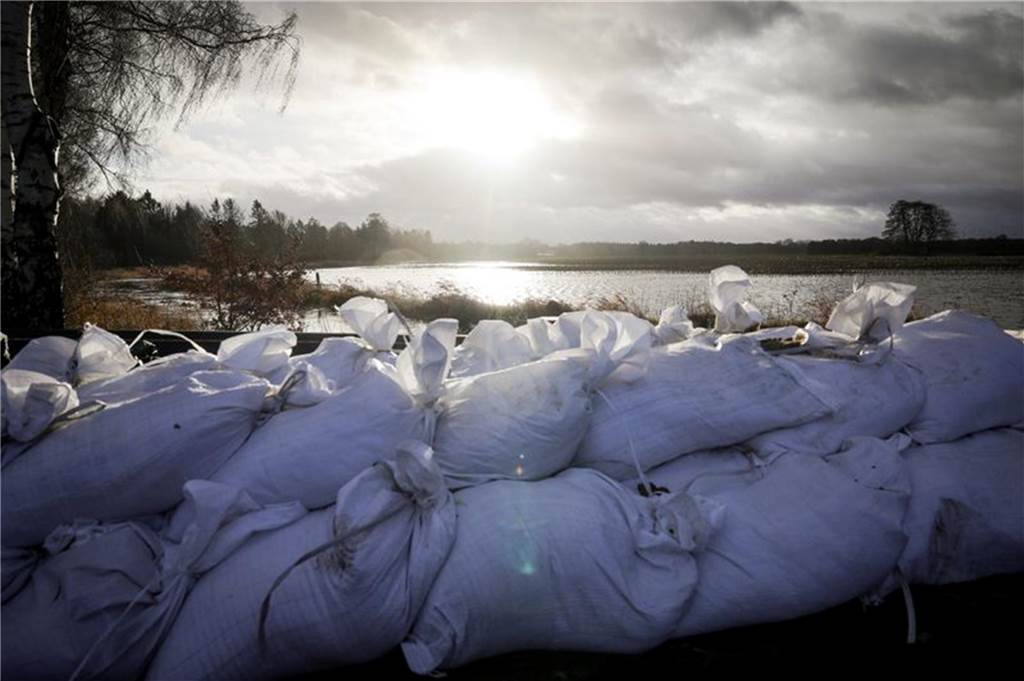 Hochwasserlage in NRW weiter angespannt, aber stabil: Schnee und Glätte in den nächsten Tagen Niedersachsen: Sandsäcke am Ortseingang von Sandkrug bei Oldenburg.