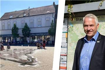 Olfens Bürgermeister Wilhelm Sendermann grillt für die Olfener zugunsten der Ukraine Würstchen auf dem Marktplatz.