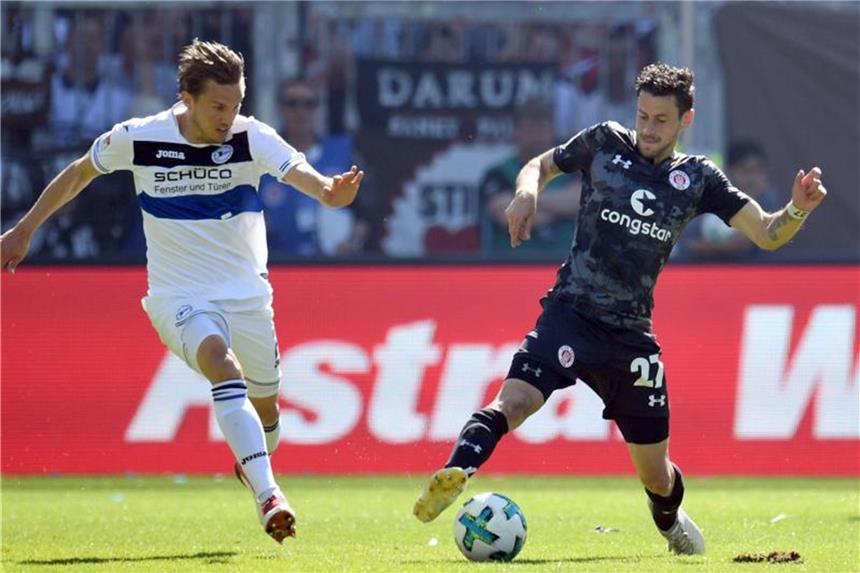 Sieg gegen Bielefeld: FC St. Pauli feiert Klassenverbleib Paulis Jan-Philipp Kalla (r) und Bielefelds Konstantin Kerschbaumer kämpfen um den Ball. Foto: Daniel Reinhardt