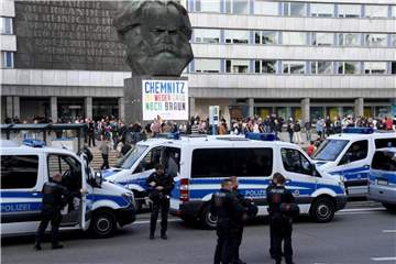 Polizeifahrzeuge stehen vor dem Karl-Marx-Denkmal. Foto: Hendrik Schmidt