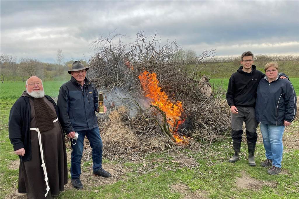 Osterfeuer der Kolpingsfamilie Werne: Mehr als nur Rauch und Feuer Präses Norbert Schlenker (v. l.), Norbert Schmid sowie Monika Lochthofen-Hagemann und Jan-Frederic Lochthofen vor dem geraden entzündeten Feuer an der Capeller Straße.