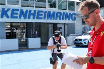 Sebastian Vettel geht über die Rennstrecke des Hockenheimrings. Foto: Jan Woitas