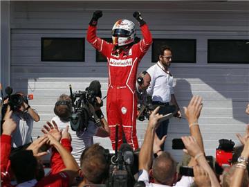 Sebastian Vettel vom Team Scuderia Ferrari jubelt über seinen Sieg beim Grand-Prix von Ungarn. Foto: Darko Bandic