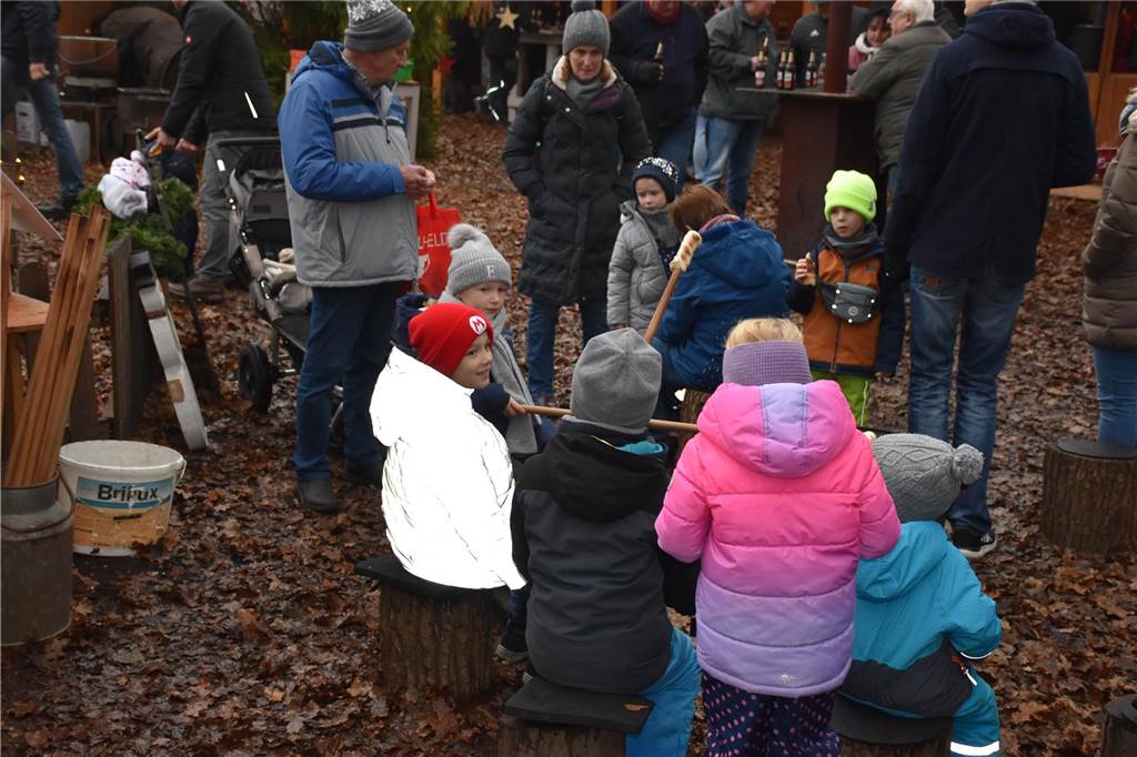 Menschen feiern auf dem Weihnachtsmarkt auf Hof Lenz in Ascheberg 2024.