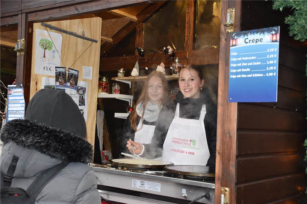 Menschen feiern auf dem Weihnachtsmarkt auf Hof Lenz in Ascheberg 2024.