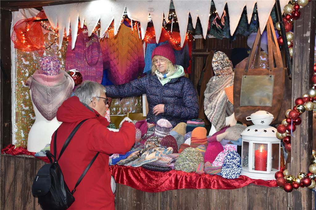 Menschen feiern auf dem Weihnachtsmarkt auf Hof Lenz in Ascheberg 2024.