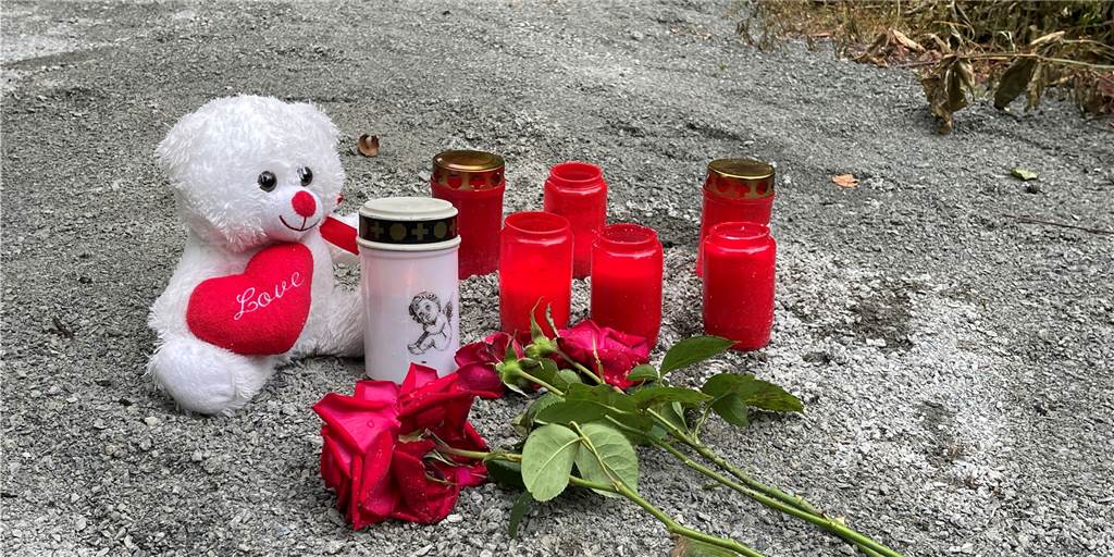 Ältere Zeugin hilft Polizei am Leichenfundort bei Werne-Stockum Kerzen, Blumen und ein Teddybär auf einem Weg.