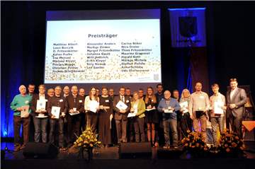 Über 20 Preisträger waren auf der Bühne der Europahalle bei der Verleihung der Sportplaketten und Urkunden durch den Ersten Beigeordneten Michael Eckhardt (2.v.l.) und Bürgermeister Rajko Kavanja (r).