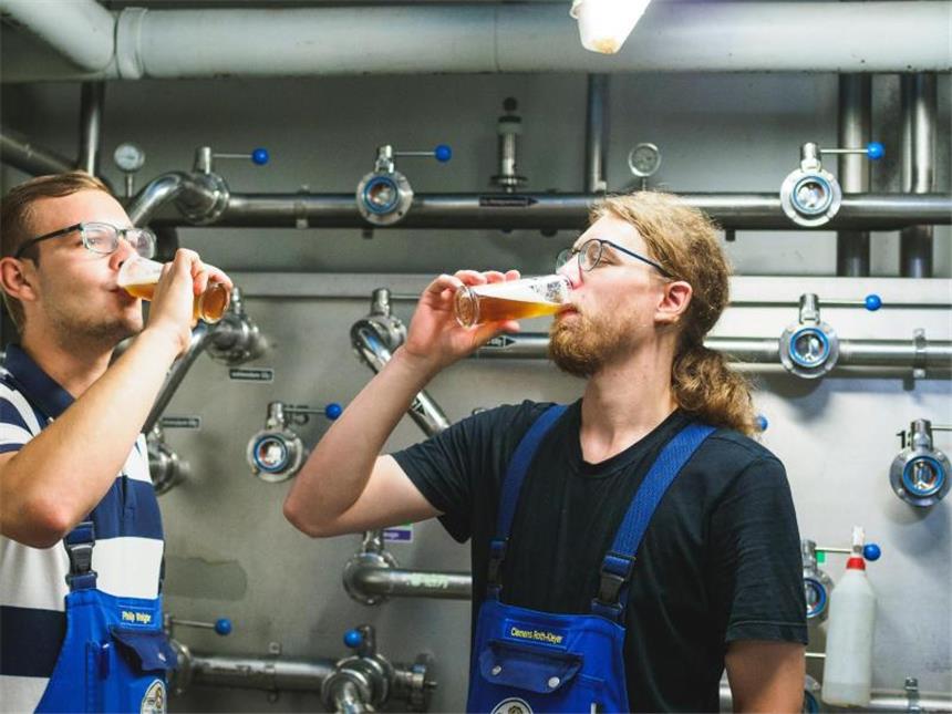 Wie werde ich Brauer und Mälzer? Und Prost! Die Brauer Clemens Roth-Kleyer (r)und Philip Weigler bei der sogenannten Verköstigungsprobe. Foto: Nicolas Armer/dpa-tmn