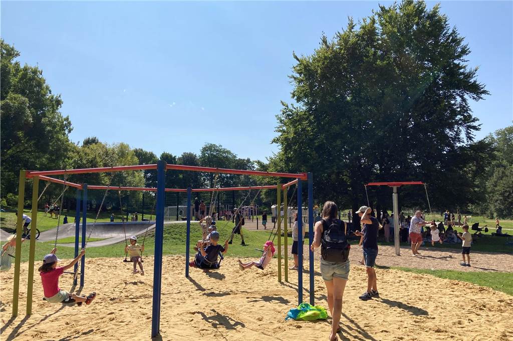 Zu sehen sind spielende Kinder, deren Eltern und weitere Besucher, die zur Eröffnung neuen Superspielplatz in Castrop-Rauxel gekommen sind.