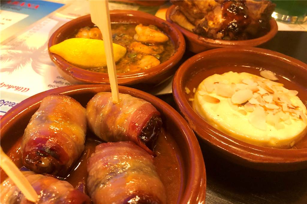 Im Copacabana schmeckt‘s gut – auch wenn es von Ahaus ein ganzes Stück bis Südamerika ist Vier warme Tapas im Tonschälchen: Datteln im Speckmantel, Garnelen in Kräuteröl, gebackener Ziegenkäse mit Honig und Spareribs.