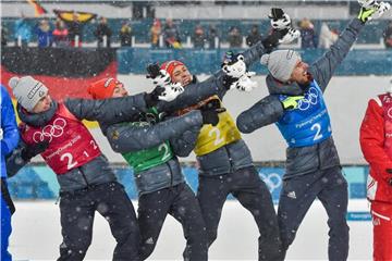 Vinzenz Geiger (l-r) Fabian Rießle, Eric Frenzel und Johannes Rydzek posieren nach dem Gewinn der Goldmedaille wie Usain Bolt. Foto: Angelika Warmuth
