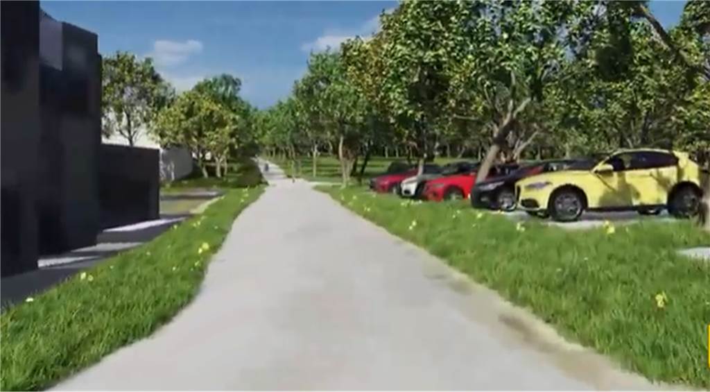 Ein Parkplatz mit parkenden Autos befindet sich am Rande des geplanten Wohnquartiers, rechts ist Bestandsbebauung. 