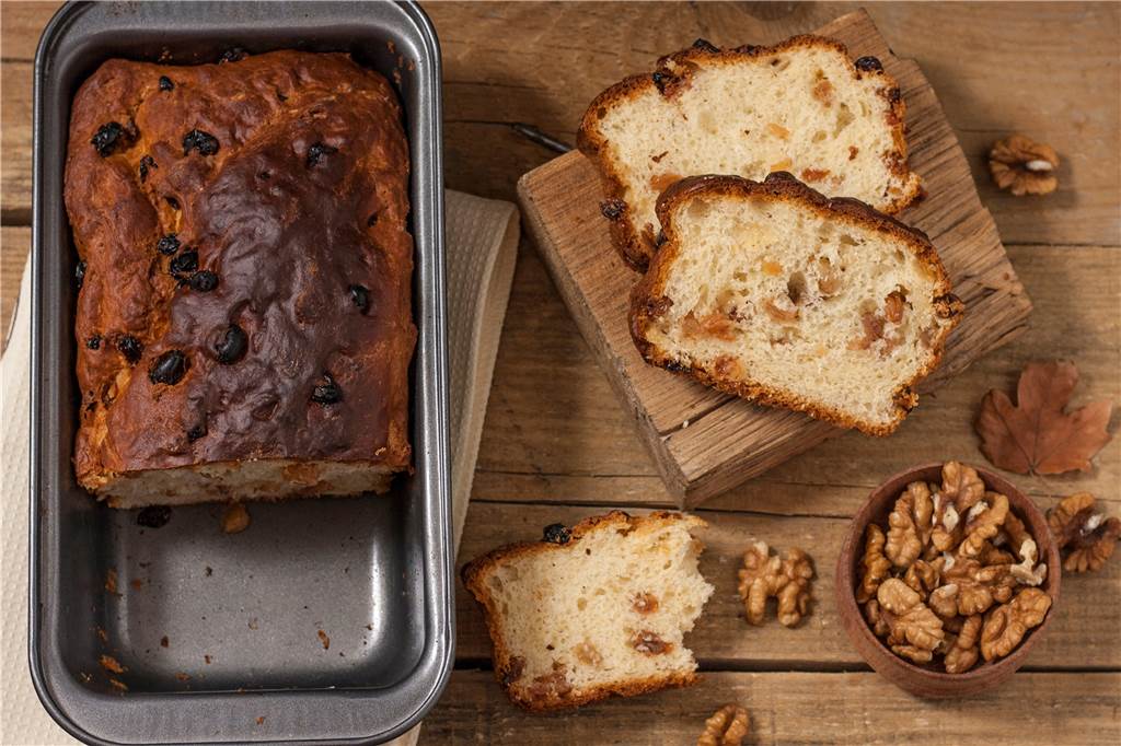 nussbrot in einer backform und bereits abgeschnittene stücke