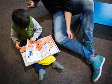 Wollen Eltern ihre Kinder mehrsprachig erziehen, sollten sie jeweils konsequent eine Sprache sprechen. Auch Bücher und Filme können die Sprachentwicklung fördern. Foto: Maja Hitij/Archiv