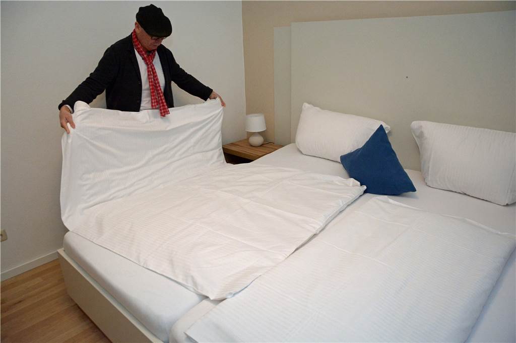 Werner Stadthotelbetreiber: „Ich bin noch hier – aber wo seid Ihr?“ Horst Nußbaum macht ein Bett in einem Hotelzimmer.